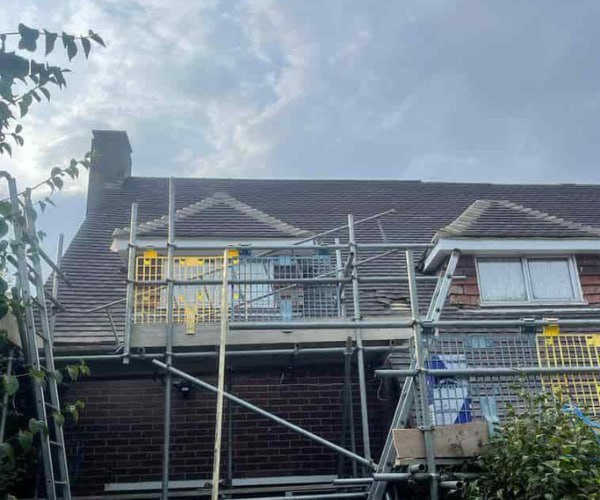 This is a photo of a roof with two dormers that is having some damaged tiles replaced. Works carried out by CGT Roofing Newport Pagnell