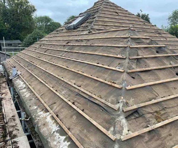 This is a photo of a hip roof that has been stripped back to the battens, and is awaiting a new roof covering to be installed. Works carried out by CGT Roofing Newport Pagnell